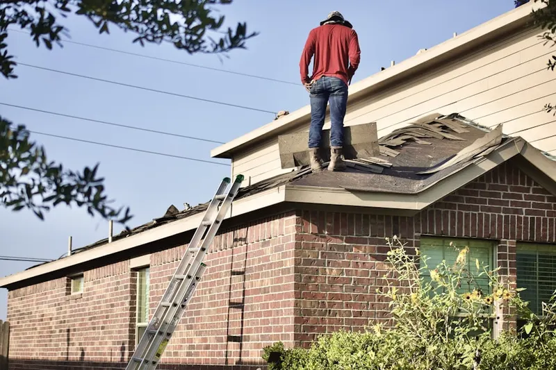 Professional roofer working on a residential roof in Evant